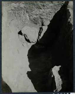 Excavation trench at Stylli with large stones set in a pale soil face