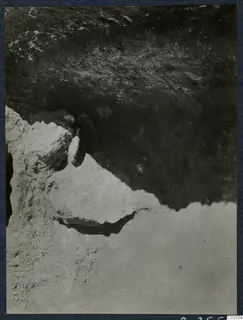 Close view of an excavated soil face at Stylli, with stones embedded in the section.