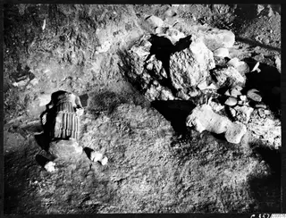 Finds in situ at Cholades, Soli: a headless draped stone figure and fallen stone blocks in excavated ground
