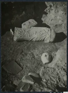 Finds in situ at Cholades, Soli: a carved stone head and a carved stone block lying in excavated ground