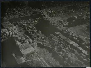 Excavated stone walls and rubble at Soli, Cholades Temples, with dressed stone blocks in a line.
