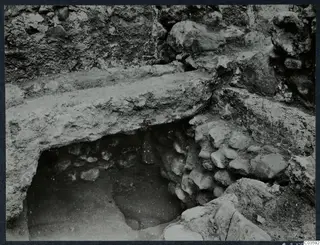 Excavated stone walls and a flat stone slab at the Cholades Temples A-B, Soli.
