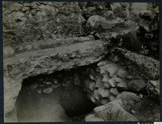 Excavated walls and stones at Soli, Cholades Temples A-B, with a large stone slab over a dark opening