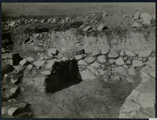 Excavated stone walls and rubble at the Cholades Temples A-B at Soli, seen from a trench.