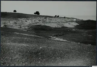 Excavated temple remains at Soli, with a white tent on the right and the sea beyond.
