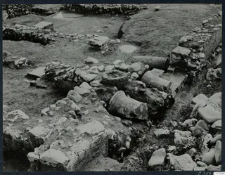 Excavation at Cholades, Soli, with fallen column drums and wall foundations among scattered stones.