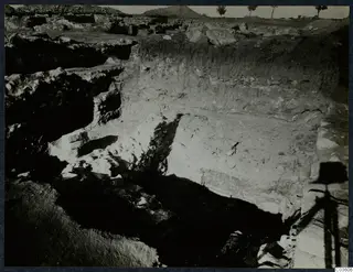 Excavation trench at the Cholades temples A-B, Soli, with exposed stone walls and a tall soil section