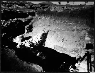 Excavation trench at the Cholades temples A-B at Soli, with exposed stone walling and a layered soil section