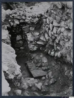 Excavation trench at Soli with rubble stone walls and a flat stone slab on the floor, Cholades temples area.