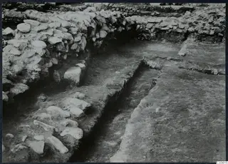 Excavated stone walls and a paved surface at Soli, Cholades temples