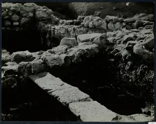 Excavated stone walls and a long stone slab at Cholades, Soli