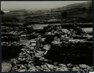 Excavated stone walls and foundations at Soli, Cholades temples, with fields and hills beyond