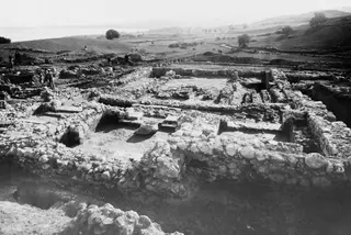 Temple E at Cholades, general view from the west, showing excavated stone walls and workers at the trenches