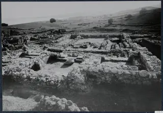 Temple E at Cholades, general view from the west, showing excavated stone walls and workers on the left