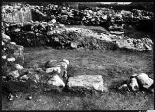 Excavated stone walls and a large squared stone block at the Cholades temples, Soli