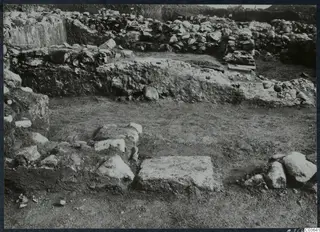 Excavated stone walls and foundations at Soli, Cholades Temples A-B, with a large flat stone block in the foreground.