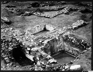 Cisterns 169 and 170 at Cholades, Soli, seen from the south, with stone walls and water in a plastered basin