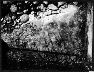 Wall painting of diagonal lines and a lattice pattern on plaster in Room X at Soli, Cholades.