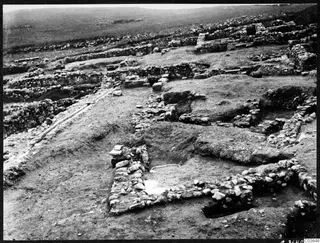 Excavated stone walls and foundations at Soli, Cholades Temples A-B, seen from above across a dug ground surface