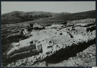 Excavated stone walls of Temples A-B at Soli, Cholades, on a hillside with hills behind