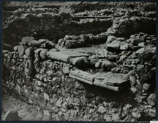 Excavated stone walls and a flat stone slab at Soli, Cholades Temples C-F.