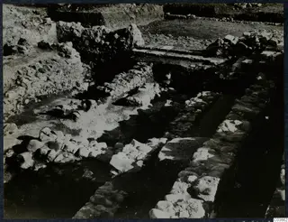 Excavation at Soli showing lines of rough stone walls and foundations with trenches between them