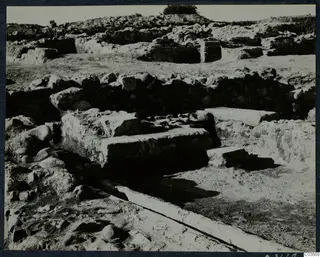 Excavated ruins at the Cholades temples A-B at Soli, with low stone walls and large cut stone blocks.