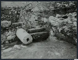 Excavated stone steps and a fallen column drum beside rubble walls at Cholades, Soli.