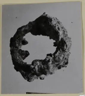 Corroded ring-shaped bronze object from Vouni, a personal adornment.