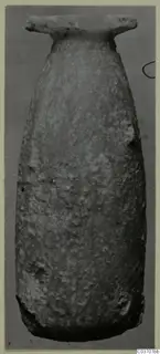 Stone vase from Vouni, with a tall narrow body and a wide flat rim