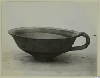 Pottery Levanto-Helladic Ware Bowl-Jar, a dark shallow bowl with a single loop handle, seen from the side