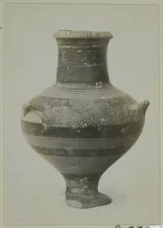 Pottery bowl-jar with two small lugs on the shoulder, a tall neck, and dark banded and hatched painted decoration.