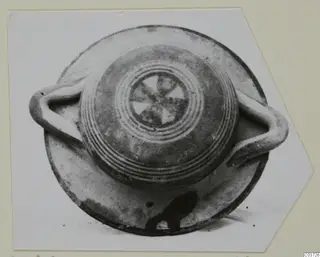 Vessel with two loop handles seen from above, with concentric rings and a radiating pattern on its top