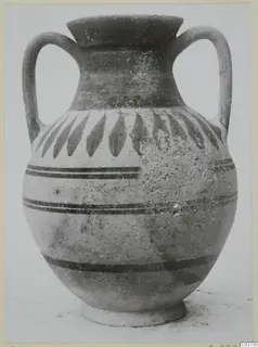 Two-handled jar with painted leaf motifs and horizontal bands, photographed against a plain background.