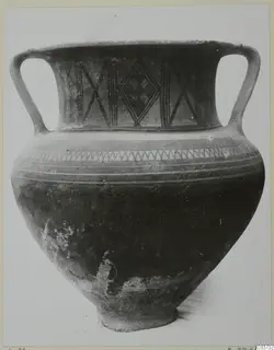 Two-handled pottery jar with black painted lattice and zigzag decoration