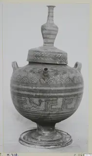 Painted pottery vessel with a rounded body, pedestal foot, two loop handles, a spout and a tall banded neck with a lid
