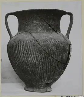 Two-handled pottery jar with vertical ribbing on the lower body, cracked and mended