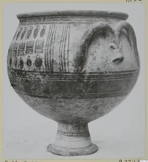 Painted pottery vessel on a high foot, with two looped handles, one with a modelled face, and bands of birds and stripes.