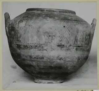 Large two-handled pottery vessel with cross-hatched and banded decoration, shown against a pale background