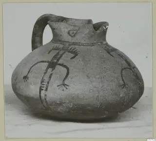 White Painted IV jug with a looped handle and dark painted figures with limbs on its rounded body