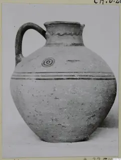 Pottery jug with a single handle, dark banded decoration and a concentric circle motif on the shoulder (White Painted III-1)