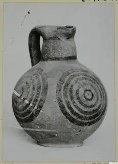 Pottery White Painted IV, a one-handled jug with dark concentric circles painted on its body