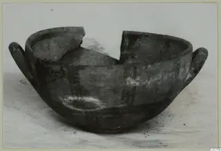 White Painted I bowl with two handles and a broken rim.