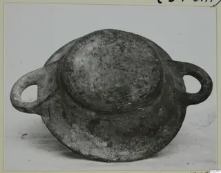 Two-handled vessel with a domed centre and broad base, grey-brown surface