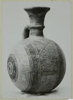 Pottery Bichrome III vessel with a strap handle, painted bands and geometric motifs on its round body