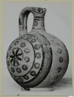 Painted pottery juglet with a strap handle, decorated with concentric circles and a central rosette