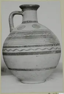 Painted jug with banded decoration, wavy lines and two concentric circles on the shoulder