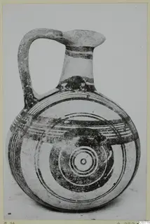 Pottery White Painted IV: jug with a single loop handle, painted bands and concentric circles on the body