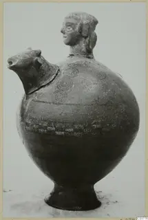 Pottery vessel with a modelled human head on the neck and an animal head forming the spout