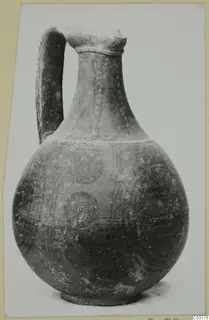 Bichrome-Red pottery jug with a single handle and concentric circles painted on its globular body